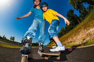 Happy young people rollerblading, skateboarding