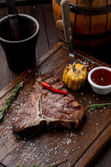 Dark atmosphere photo of a big t-bone steak, steak restaurant photo for a menu