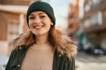 Fototapeta premium Young caucasian girl smiling happy standing at the city.
