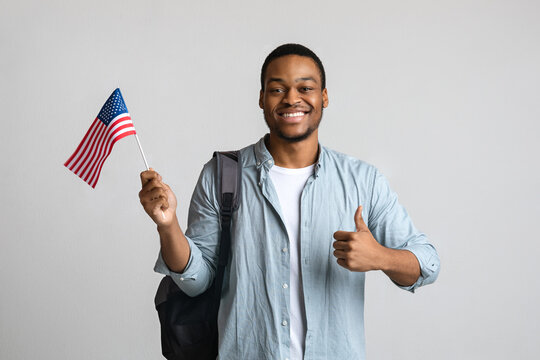 Happy black man showing thumb up and american flag