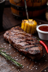 Tenderloin steak with no side dish on a dark wooden board