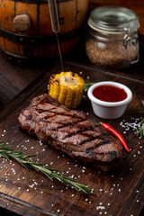 Tenderloin steak with no side dish on a dark wooden board