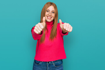Fototapeta premium Young irish woman wearing casual clothes approving doing positive gesture with hand, thumbs up smiling and happy for success. winner gesture.