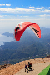 Paragliders flying from a top of Tahtali mountain near Kemer, Antalya Province in Turkey. Concept...