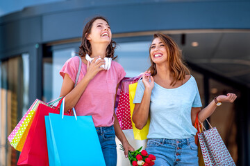 Two female friends with shopping bags