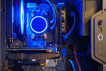 Computer parts inside pc with ice blue led liquid cooling