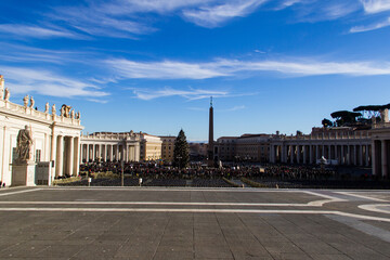 rome's vatican square, with people in the distance waiting to hear mass.
