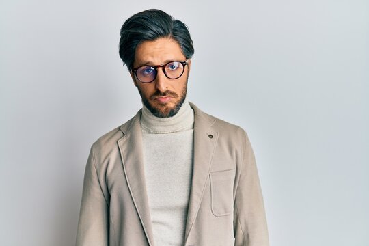 Young hispanic man wearing business jacket and glasses depressed and worry for distress, crying angry and afraid. sad expression.