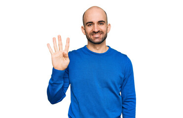 Young hispanic man wearing casual clothes showing and pointing up with fingers number four while smiling confident and happy.