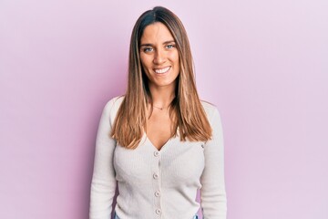 Obraz premium Brunette young woman wearing casual clothes with a happy and cool smile on face. lucky person.