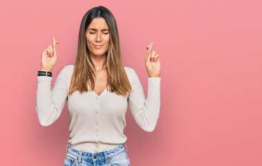 Young woman wearing casual clothes gesturing finger crossed smiling with hope and eyes closed. luck and superstitious concept.