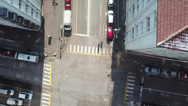 Aerial view of crosswalk and empty streets in quarantine days. sunlight seen through buildings. 