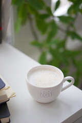 Cup of coffee on white desk