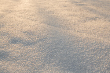 White fresh snow with sunlight on the snow   texture detail background with place for message. Footprints in the snow 