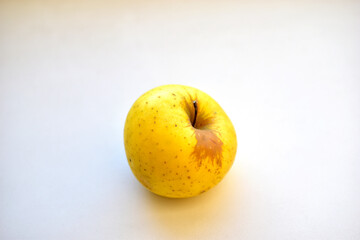 Yellow green apple on a white background close up