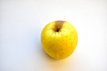 Yellow green apple on a white background close up