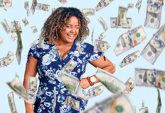 Young african american plus size woman wearing casual clothes winking looking at the camera with sexy expression, cheerful and happy face.