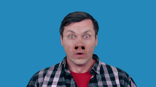 Funny portrait of a man with a pig nose. Blue background.