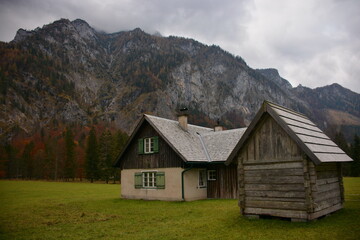 Fototapeta na wymiar Old house in the mountains and a wooden shed