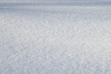 White snow texture on clear day. Winter background. Snow drifts. white snowflakes background, rough pattern of snow texture
