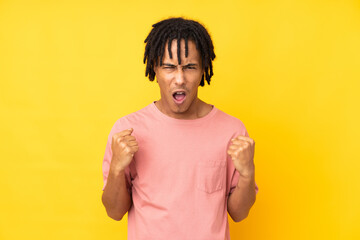 Young african american man isolated on yellow background frustrated by a bad situation
