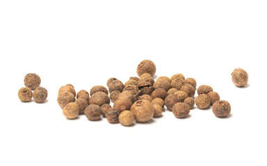 Dried herb, allspice in the olive wood scoop, isolated on white