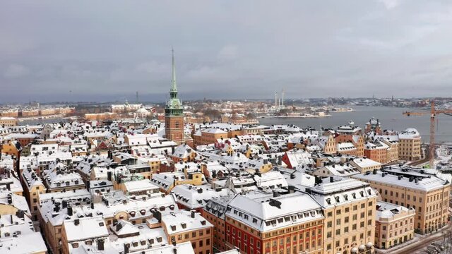 Old town gamla stan stockholm Sweden in Winter. White snow on cold day on old buildings in city center. Flying drone aerial shot