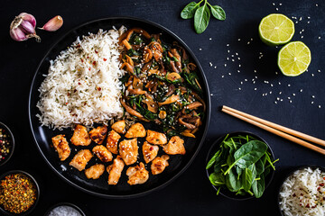 Chicken nuggets with white rice and oyster mushrooms  on wooden table