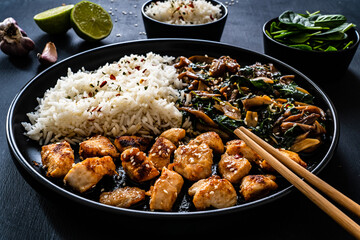 Chicken nuggets with white rice and oyster mushrooms  on wooden table