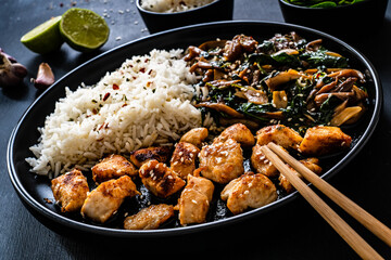 Chicken nuggets with white rice and oyster mushrooms  on wooden table