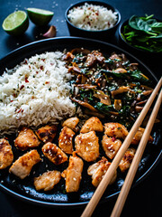 Chicken nuggets with white rice and oyster mushrooms  on wooden table