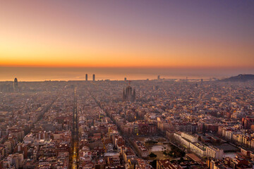 Aerial drone shot of Barcelona city before sunrise golden hour