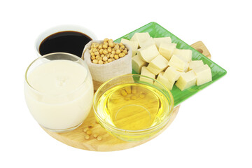Soybeans and different soy products - milk, sauce, oil and tofu on wooden cutting board isolated on white