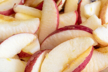 Sliced red apple wedges for a healthy snacks or to make an apple pie, close up, macro