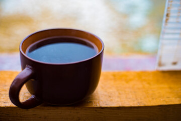 cup of coffee on wooden table
