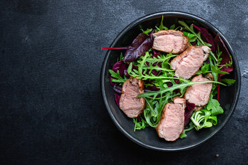 salad duck breast mix greens lettuce leaves ready to eat portion on the table for healthy meal...