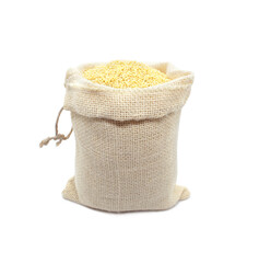 Millet in burlap sack isolated on white background. Raw yellow millets in a jute bag.