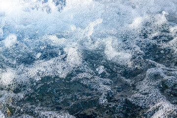 Dark bubbling water surface. Abstract defocused background
