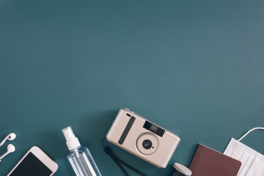 top view travel concept with camera, map, passport and disposable face mask, Tourist essentials, vintage tone effect