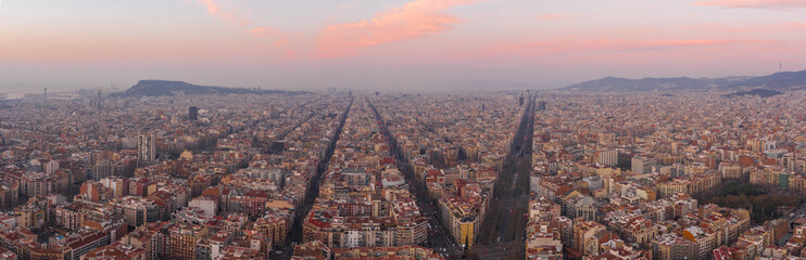 Pano aerial drone shot of Barcelona city center before sunrise in winter