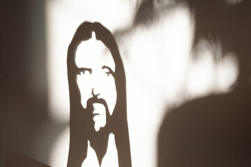 Face of jesus Christ, shadow on the wall portret, christian religion son of God, savior and redeemer
