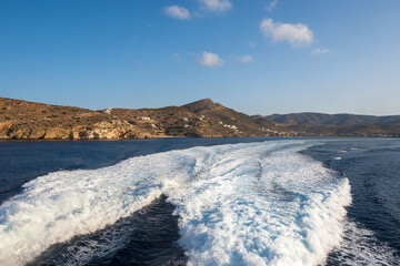 Water trail foaming behind a ferry boat in Aegean Sea near Ios island. Cyclades, Greece.