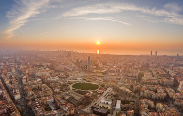 Fototapeta premium Aerial drone shot of agbar tower by Barcelona beach with sunrise