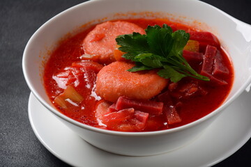 Hot red beet Kubbeh soup, a famous middle eastern dumplings soup dish, served in a bowl. A Jewish-Iraqi traditional matfuniya winter soup. Levantine dish made of bulgur, minced onions, ground  beef