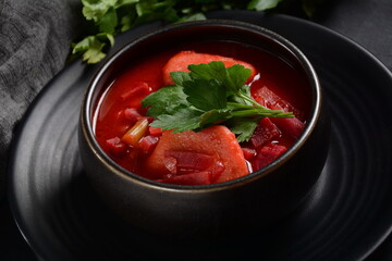 Hot red beet Kubbeh soup, a famous middle eastern dumplings soup dish, served in a bowl. A Jewish-Iraqi traditional matfuniya winter soup. Levantine dish made of bulgur, minced onions, ground  beef