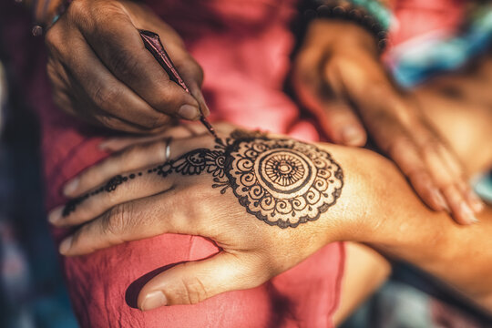 Henna art on woman's hand.