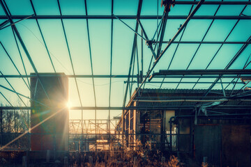 Fototapeta premium Abandoned industrial steel frame construction in teal & orange look in the midday sun