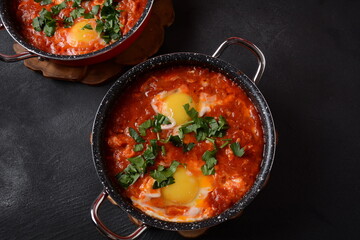 Shakshouka, eggs poached in sauce of tomatoes, olive oil, peppers, onion and garlic, Mediterranean cuisine