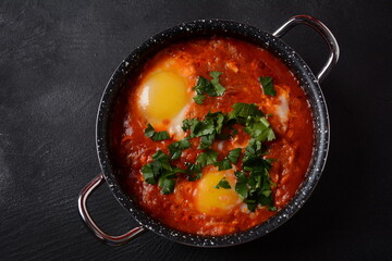 Shakshouka, eggs poached in sauce of tomatoes, olive oil, peppers, onion and garlic, Mediterranean cuisine