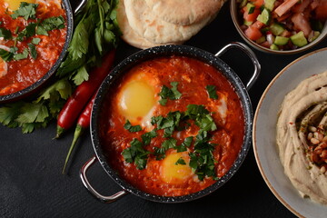 Shakshouka, eggs poached in sauce of tomatoes, olive oil, peppers, onion and garlic, Mediterranean cuisine